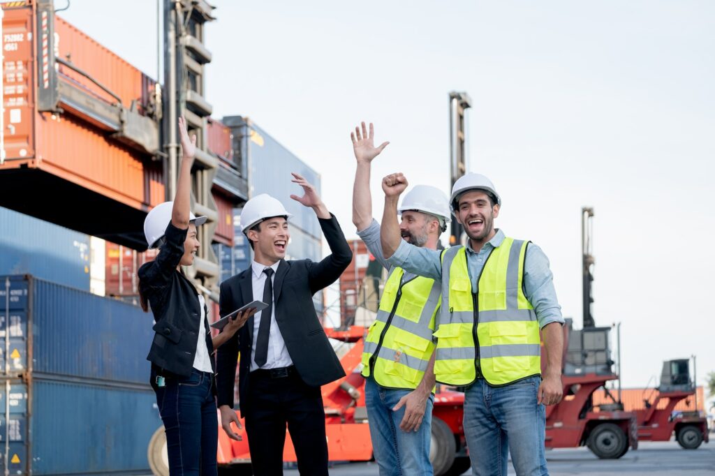 Cargo container workers or group of employee express happy emotion