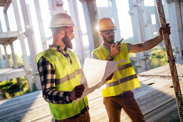 Portrait of construction engineers working on building site