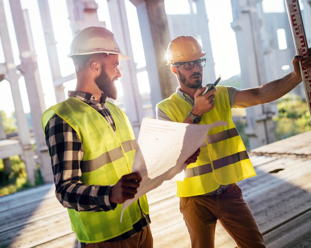 Portrait of construction engineers working on building site