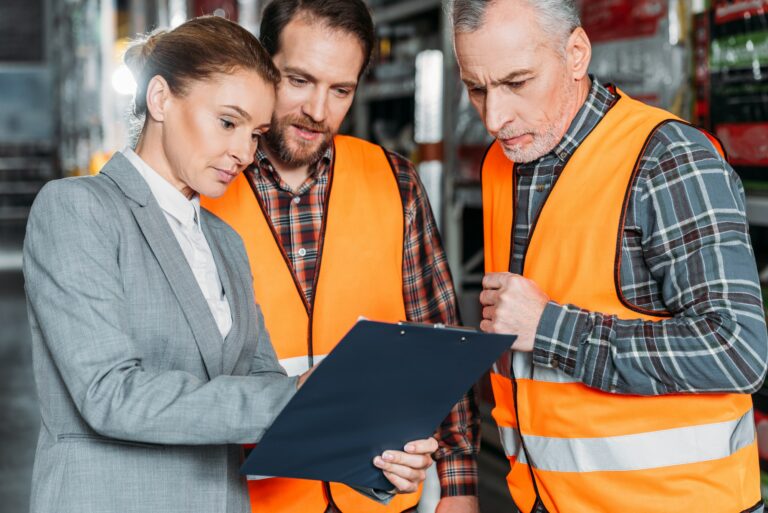 workers and inspector talking in shipping stock